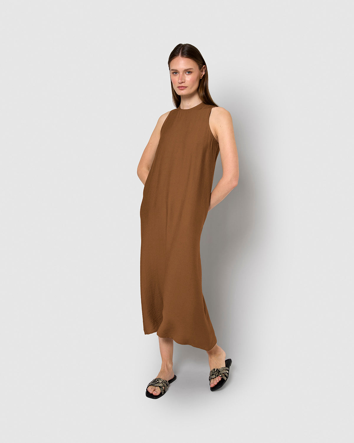 long, sleeveless, flowing brown dress