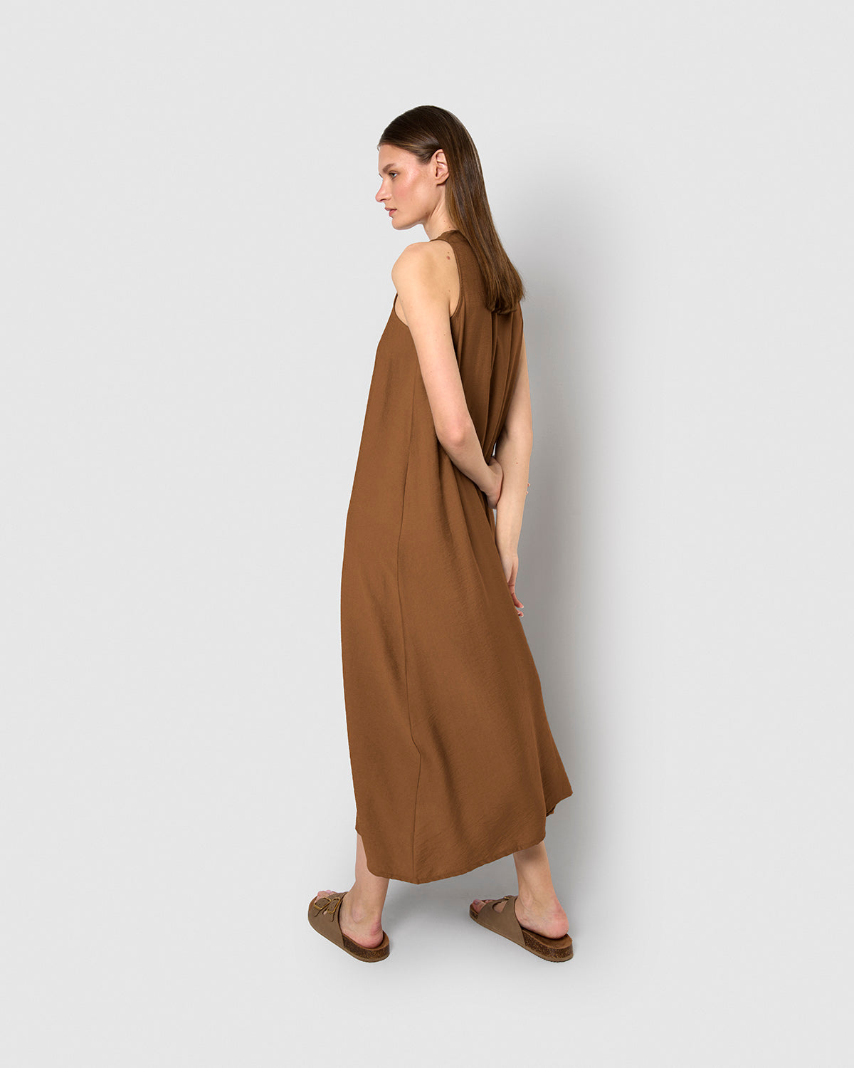 long, sleeveless, flowing brown dress