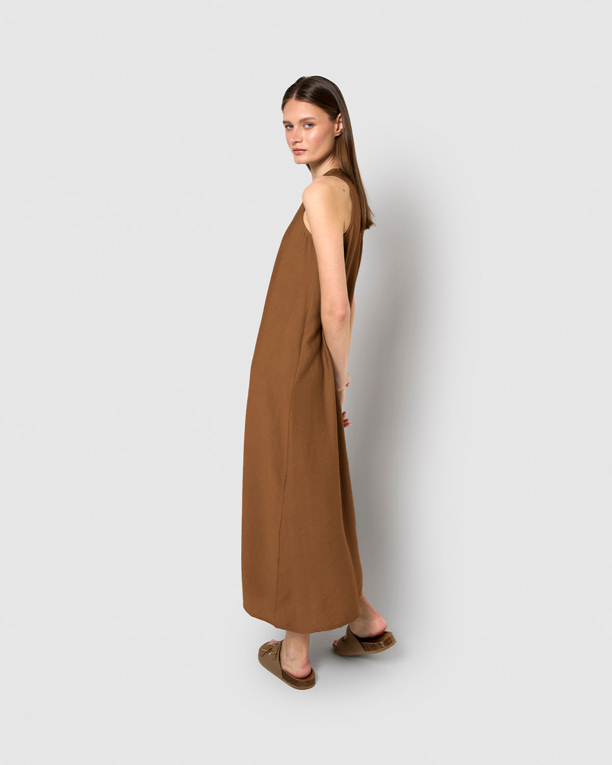 long, sleeveless, flowing brown dress