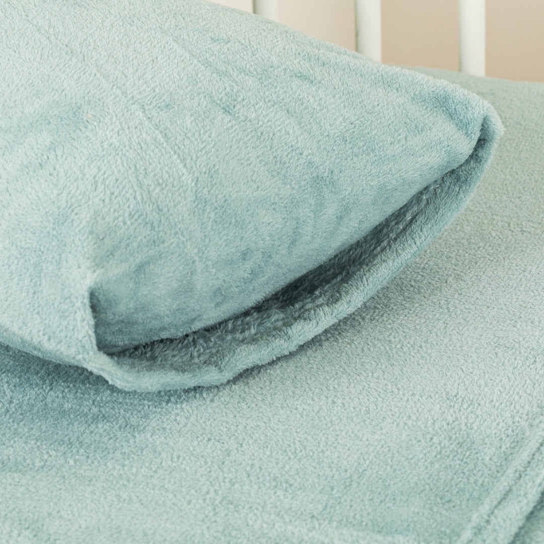 Plain coral fleece crib sheet set